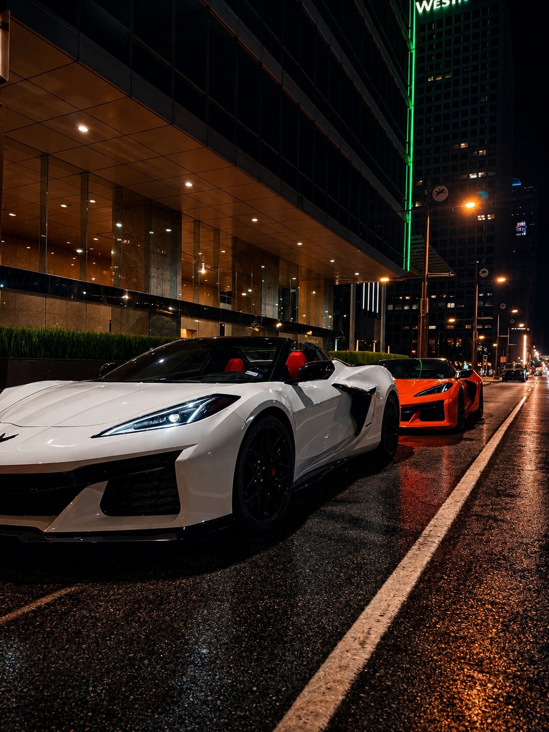Corvette Z06 rentals delivered to a downtown Dallas street at night