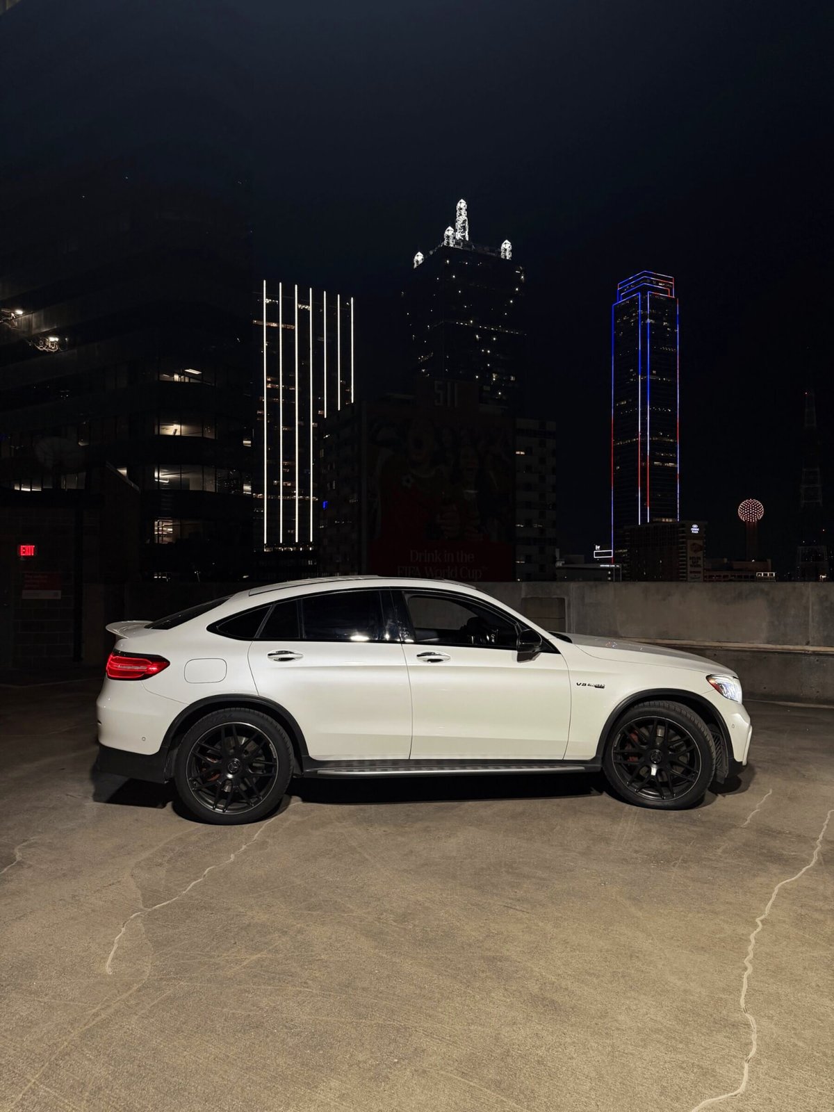 Mercedes-AMG GLC 63 S luxury suv rental parked at night in Dallas–Fort Worth