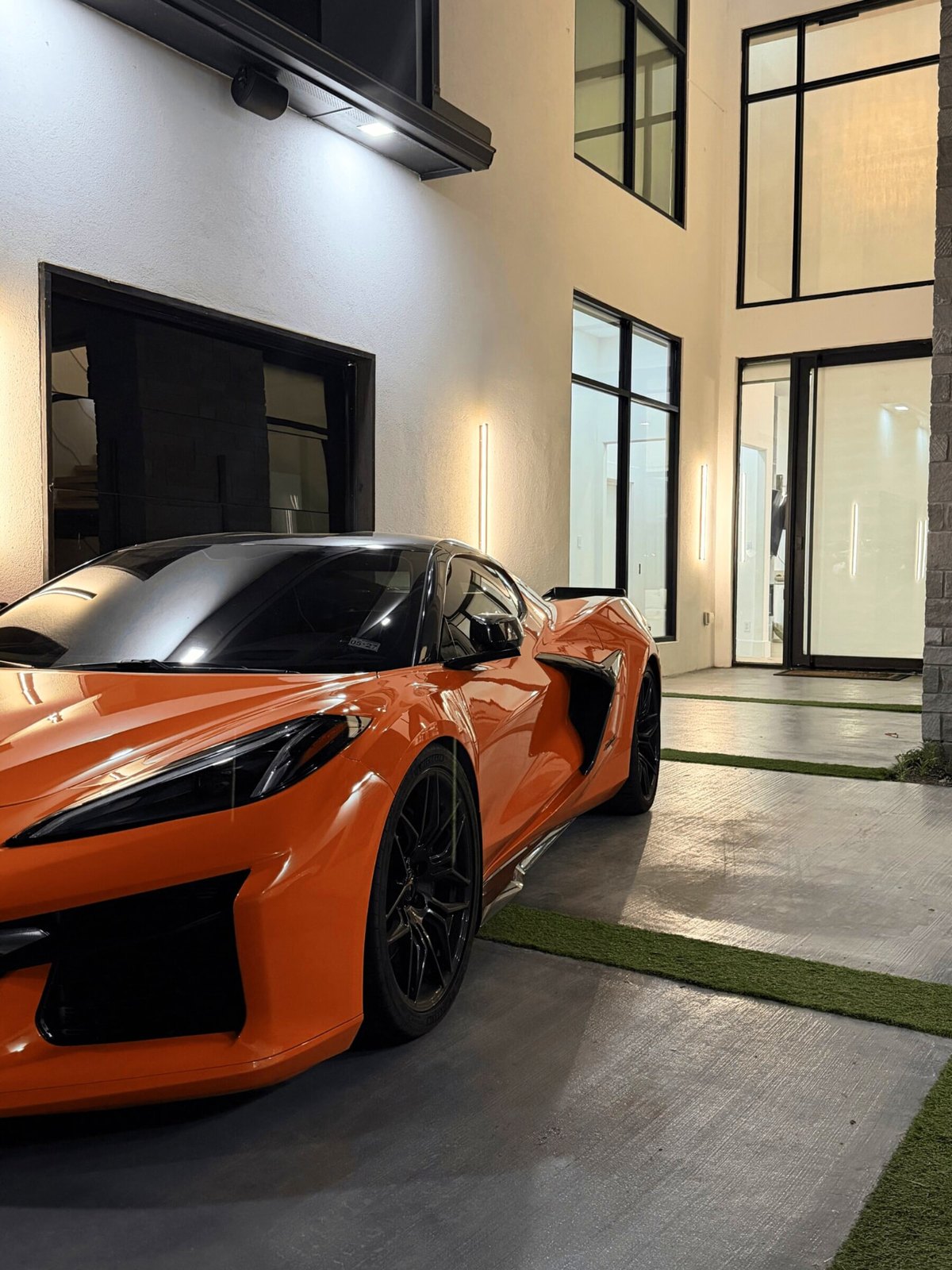 Corvette Z06 2LZ at a modern home, front three-quarter angle