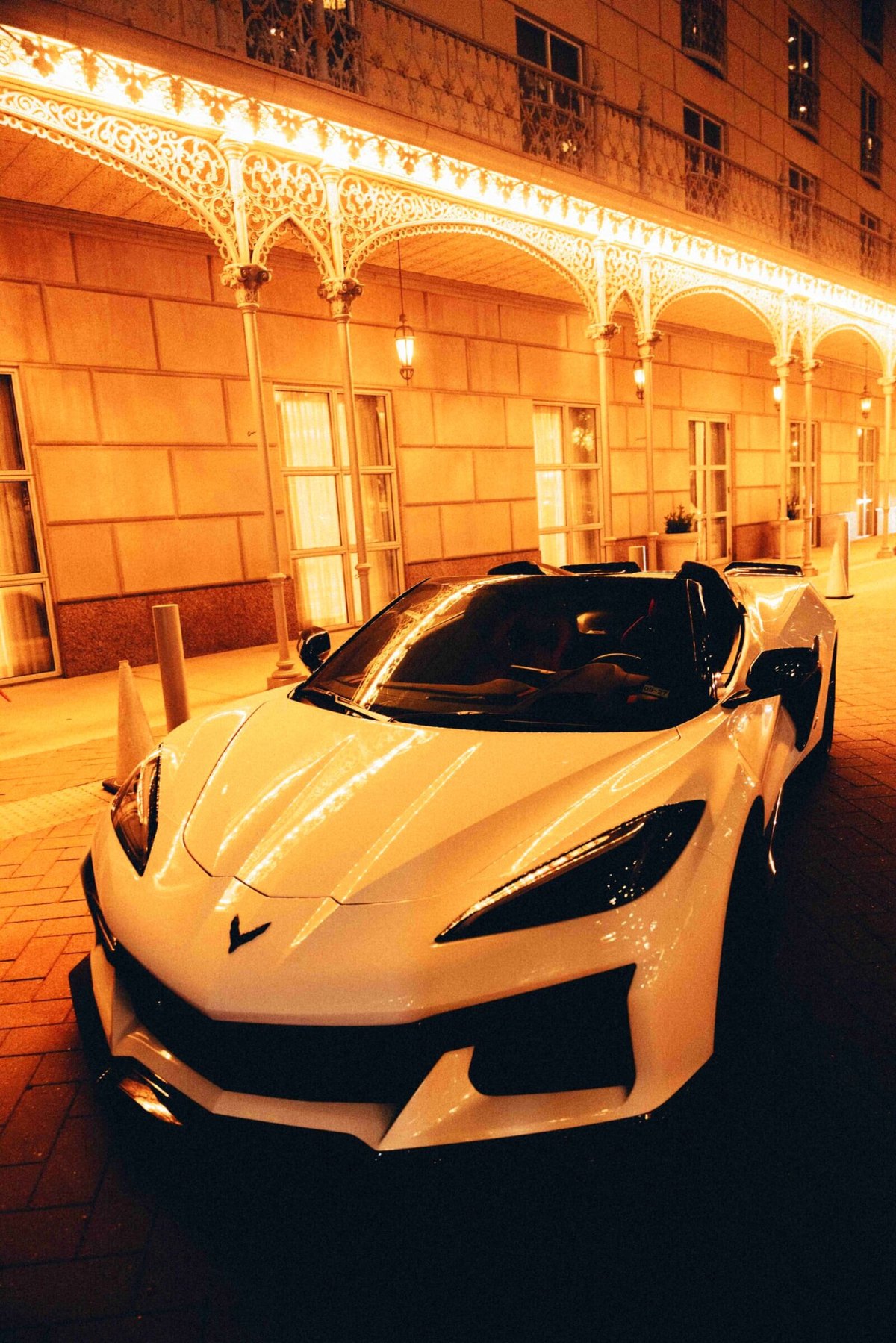 Corvette Z06 3LT at night arrival under illuminated hotel portico